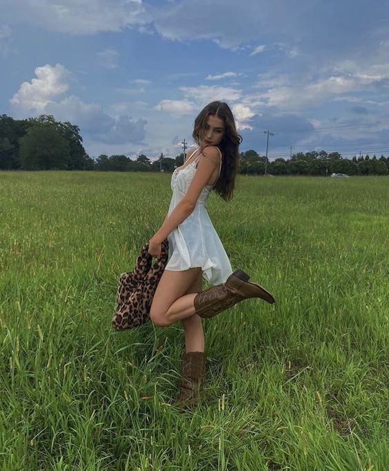 COASTAL COWGIRL — VANITY STORIES Picking Flowers Outfit, Country Outfits Women Aesthetic, Cute Country Instagram Pictures, Spring Outfits Cowboy Boots, White Dress With Brown Cowboy Boots, Dress And Brown Cowboy Boots Outfit, Rainy Walk Outfit, Latina Cowgirl Outfits Dress, Cowboy Boot With Dress