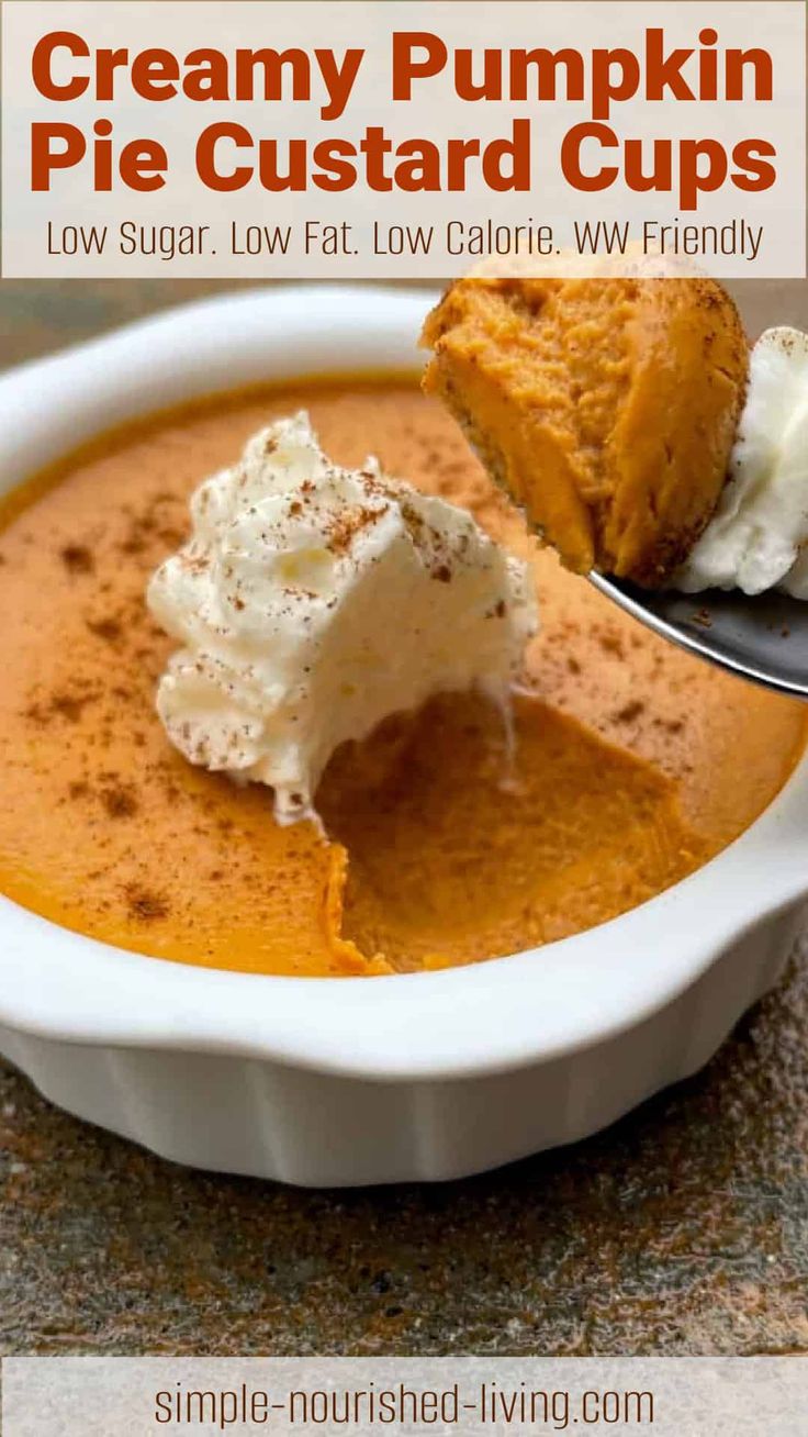 creamy pumpkin pie custard cups in a white bowl with a spoon full of cream