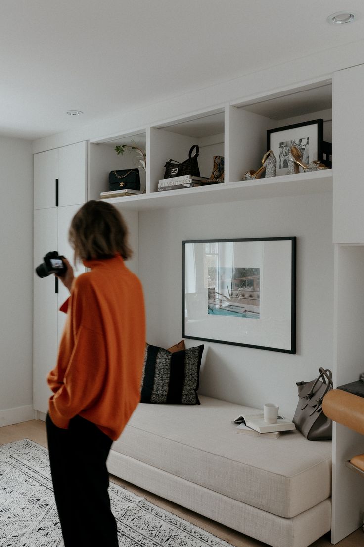 a woman standing in front of a white couch