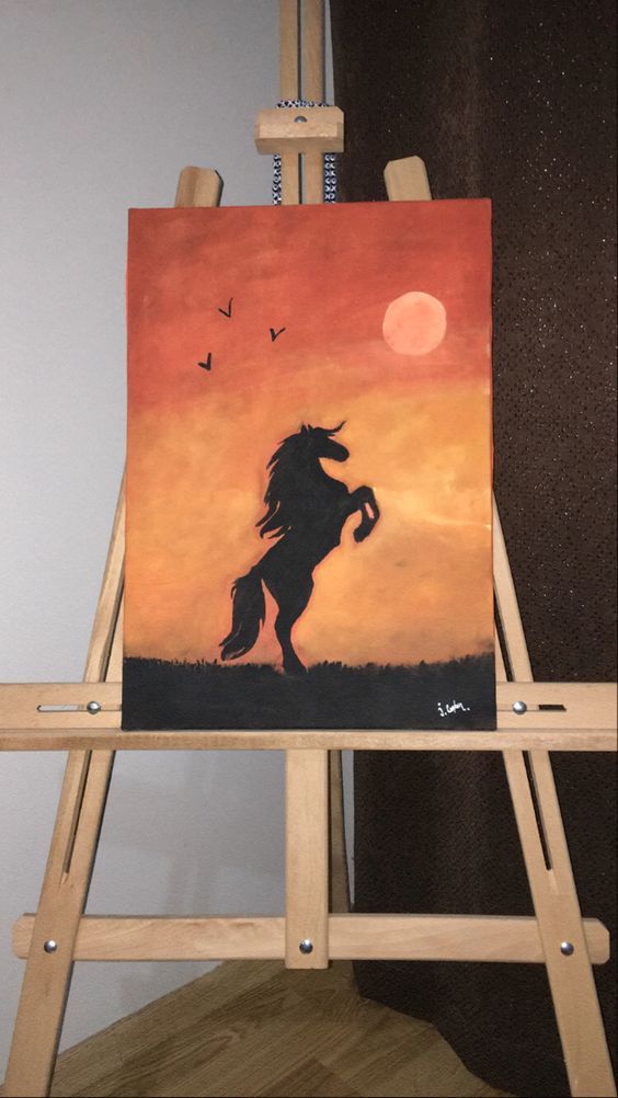 an easel with a painting of a horse on it