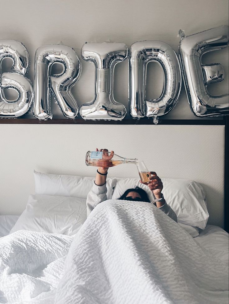 a woman laying in bed under the word bride