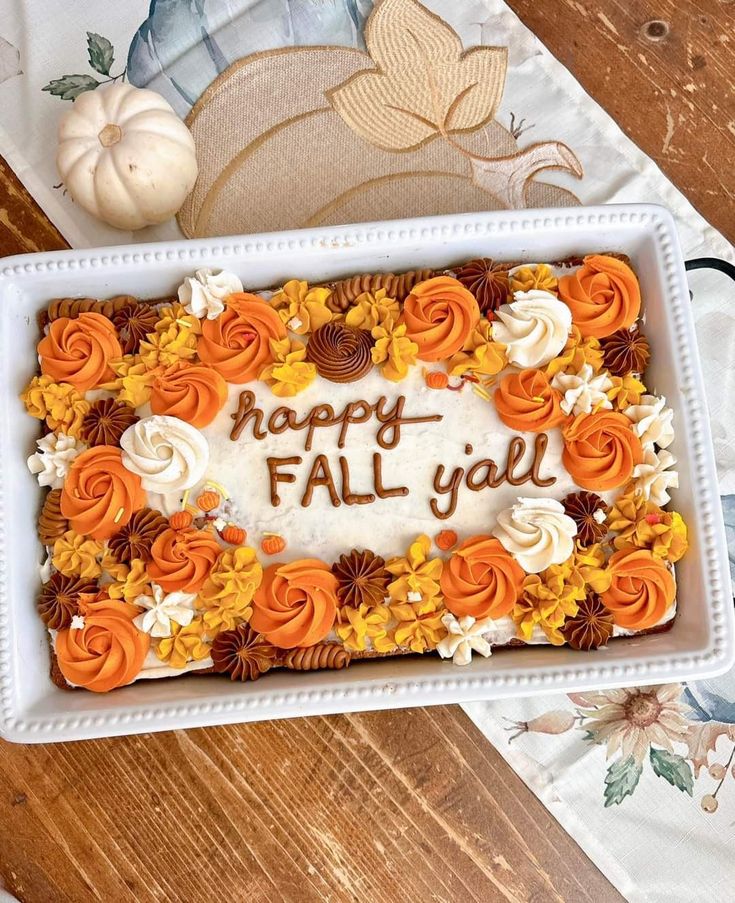 there is a cake that says happy fall y'all in the middle of it