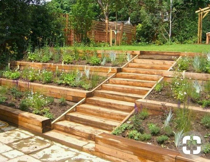 an outdoor garden with wooden steps leading up to it