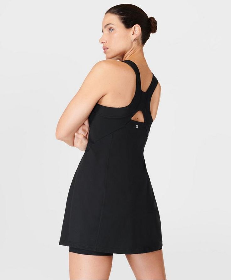 Our sporty new workout dress for styling out the sweatiest of sessions. Sweat-wicking Power Pro fabric is breathable and stretchy with a matte finish. Slim, body-skimming fit with contrasting panels and a flattering racerback. Supportive inner shorts with slip pocket. In-built bra with removable pads. Length: 77.5cm / 31". Model wears size S and is 178cm/5'10" tall. Style Code: SB9287BColour: Black Sporty Tennis Activewear With Built-in Bra, Sporty Tennis Dress With Built-in Bra For Gym, Sporty Mini Dress With Built-in Bra For Workout, Black Tennis Dress With Built-in Bra, Workout Dresses With Built-in Bra And Racerback, Fitted Tennis Dress With Built-in Bra For Gym, Sleeveless Tennis Dress With 4-way Stretch For Workout, Fitted Black Tennis Dress, Workout Tennis Dress With Built-in Bra