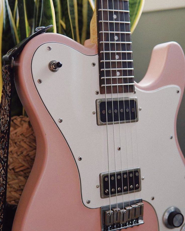 a pink guitar sitting on top of a table