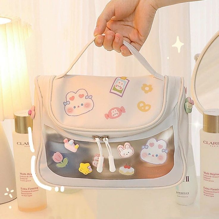 Features: Introducing our versatile and adorable Label Me Cute Large Makeup Bag! Perfectly designed to accommodate all your beauty essentials while you're on the go, this bag is a must-have for every kawaii and makeup lover out there! Comes with its own individual sticker pack, so you can personalize and decorate it any way you want! Express your creativity and style by adding your favorite stickers to your bag. With its cute and colorful design, this large makeup bag is perfect for everyday use Kawaii Makeup Bag, Cute White Pencil Case For Daily Use, Kawaii Pouch Bag With Cute Design, Cute Kawaii Pouch Bag, Kawaii Cute Pouch Bag, Kawaii Bags With Zipper Closure For Everyday Use, Cute White Pencil Case, Cute Rectangular Diaper Bag For Daily Use, Kawaii Travel Bag With Zipper Closure