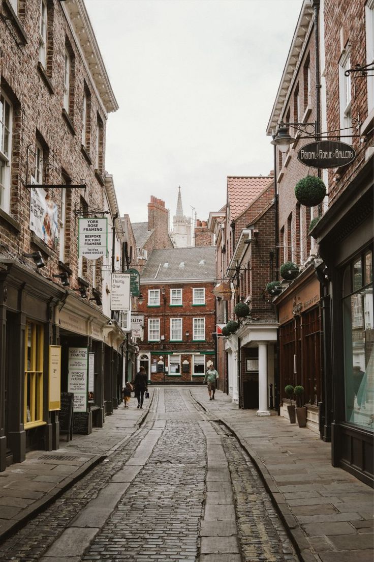 an empty street with people walking down it