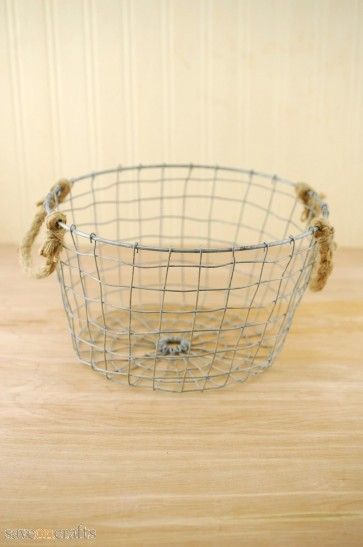 a wire basket sitting on top of a wooden table