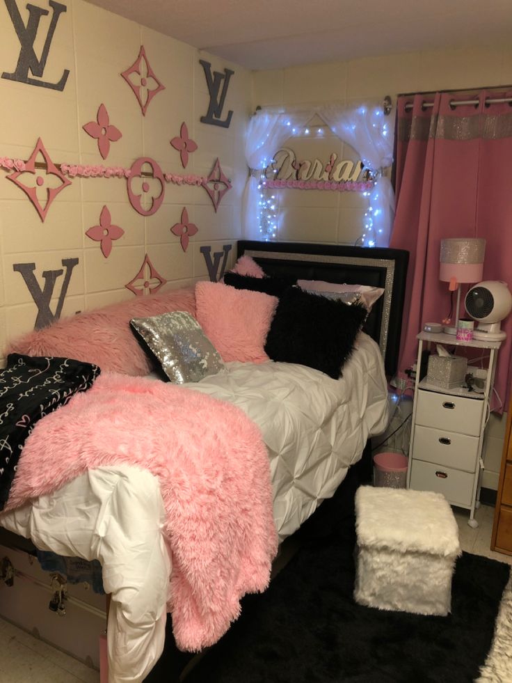 a bedroom with pink and black decor on the walls