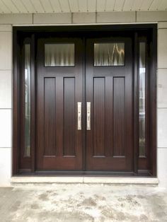 two double doors with sidelights on the outside of a house, one is brown and the other is black