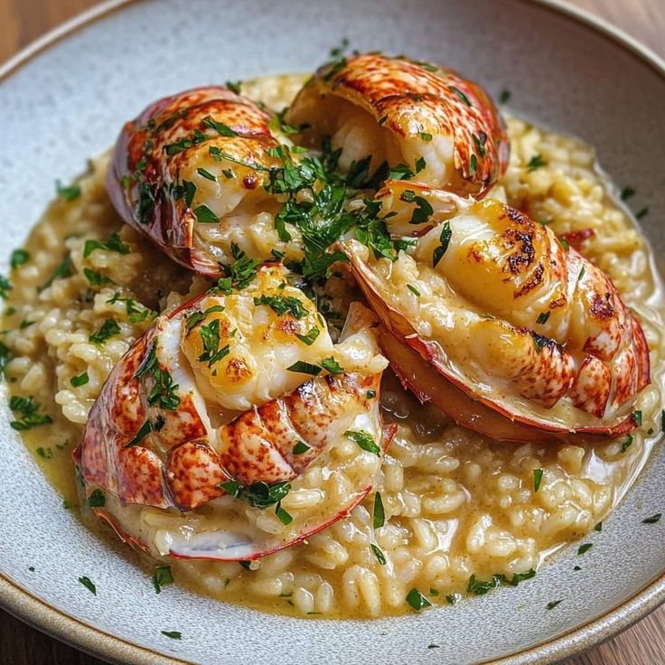 a white plate topped with riso covered in shrimp and grits, garnished with parsley