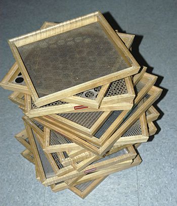 a pile of wooden frames sitting on top of a floor