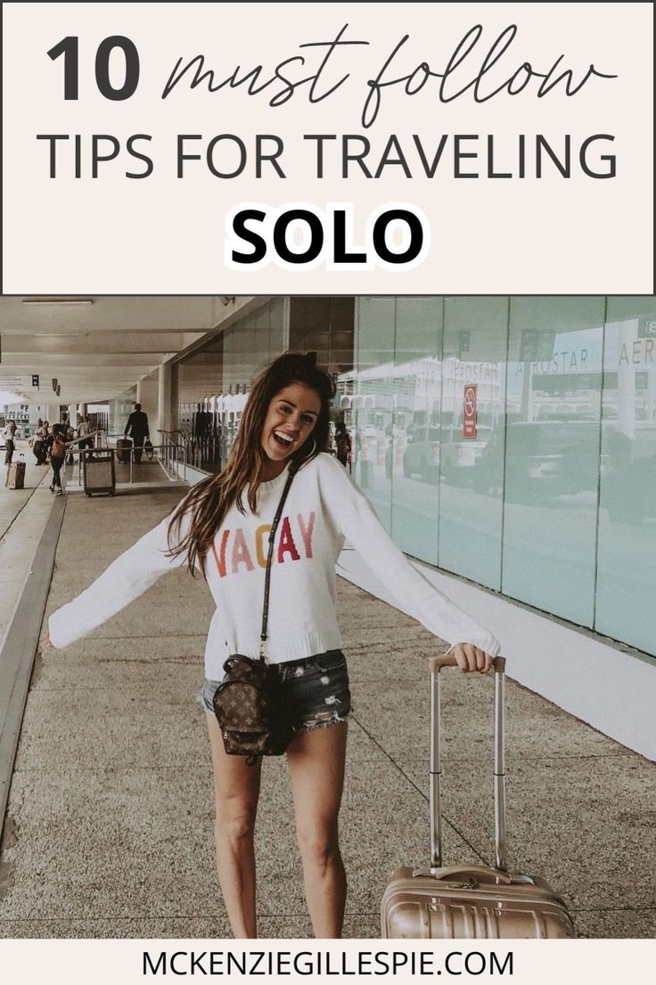 a woman holding her luggage and smiling with the words 10 must follow tips for traveling solo