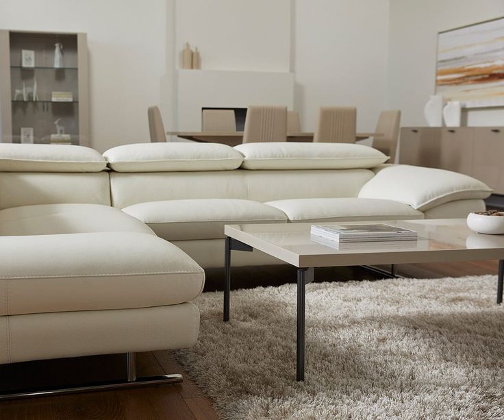 a living room filled with furniture and a white rug