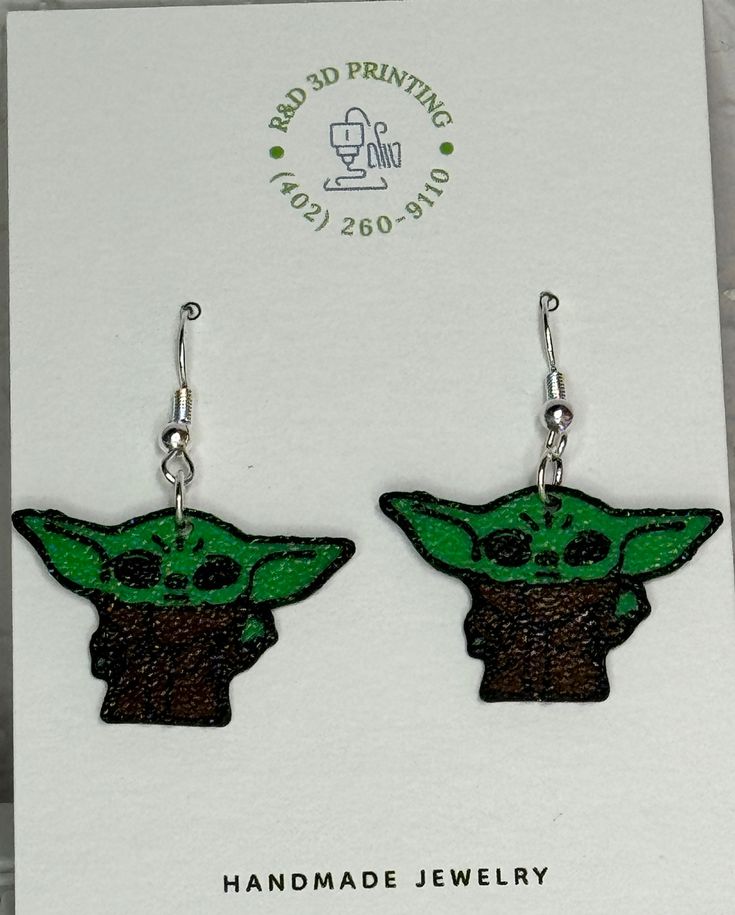 the child yoda earrings are green and black