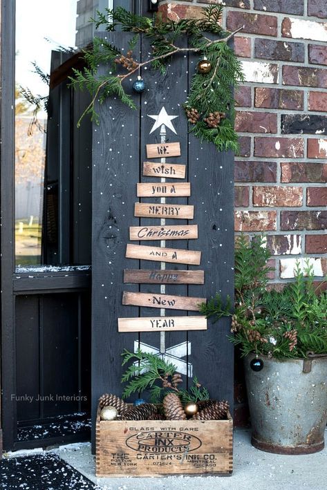 a christmas tree made out of wooden planks sitting on top of a door sill