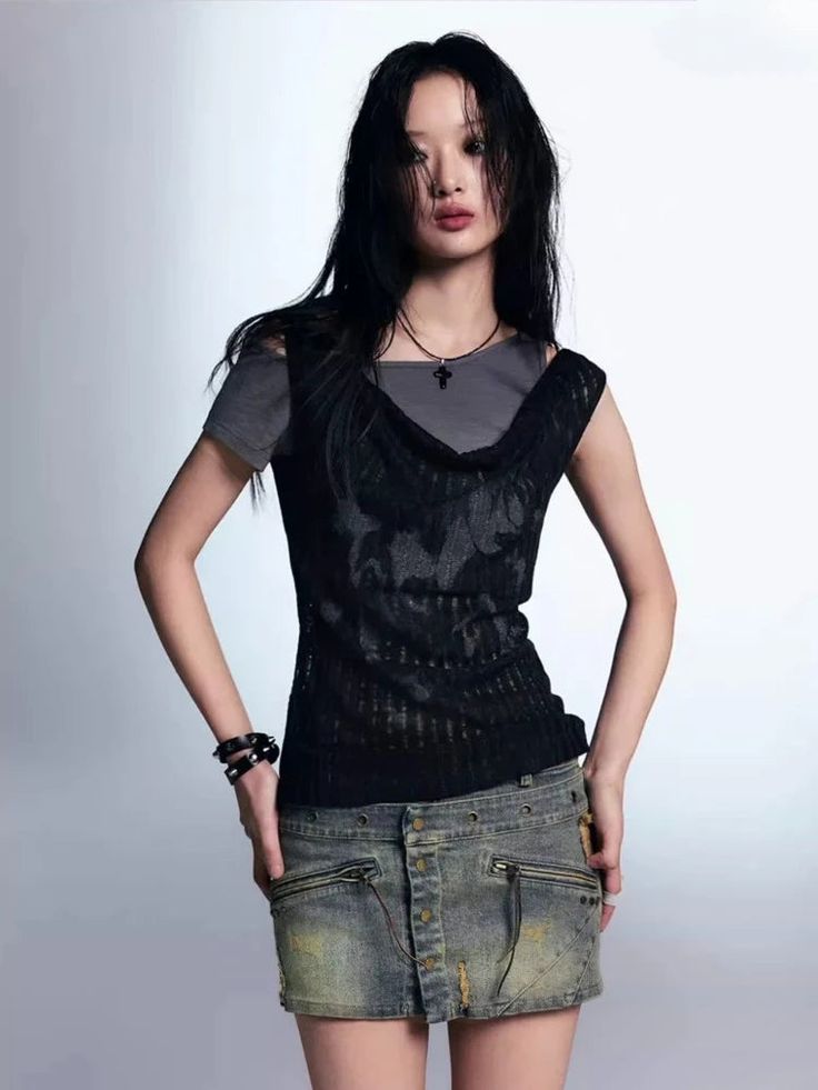 The Gothic Top combines a raw, edgy aesthetic with a unique layered look. Featuring a draped neckline and a semi-sheer overlay, this top adds depth and texture to any outfit. The contrasting layers create a distressed, lived-in feel, making it an ideal choice for those who appreciate alternative fashion and want to make a bold statement. Goth aesthetic Sheer knit top & basic top layered design Print detail at front Asymmetric neck Polyester Spring Gothic Mesh Top, Edgy Sheer Tops For Alternative Fashion, Punk Mesh Top For Night Out In Spring, Spring Punk Mesh Top For Night Out, Fitted Tops With Fake Two-piece For Layering, Grunge Tops For Fall Layering, Grunge Tops For Layering In Fall, Sheer Tops For Alternative Fashion, Grunge Tops For Spring Night Out