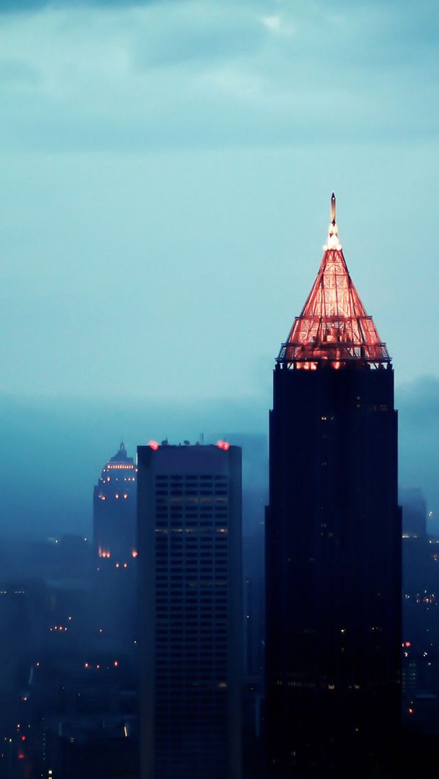 the top of a building lit up at night