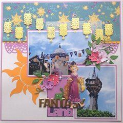 a scrapbook page with some pictures and flowers on the pages, including an image of a castle