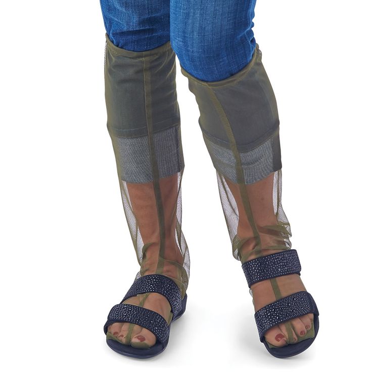 the legs and ankles of a woman wearing blue jeans, sandals and clear socks with mesh over them