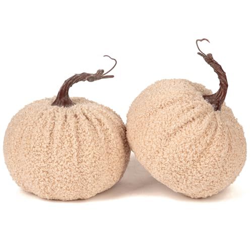 two stuffed pumpkins sitting next to each other