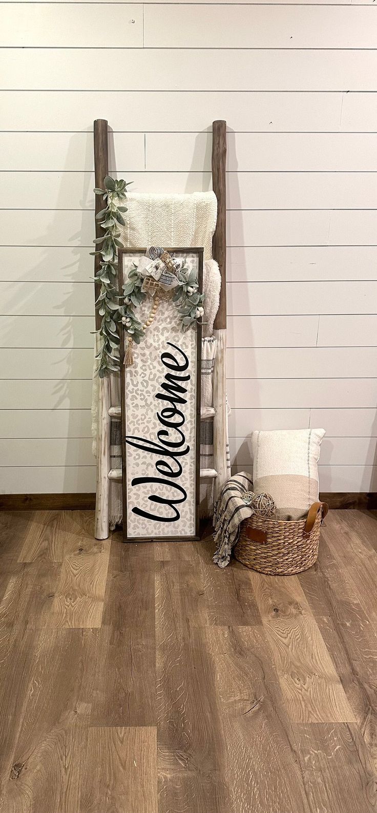 a wooden chair sitting on top of a hard wood floor next to a white wall