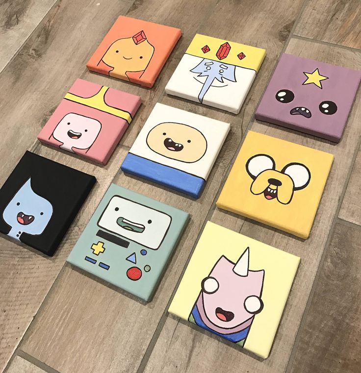 six different colored coasters with cartoon characters on them sitting on a wooden floor next to each other