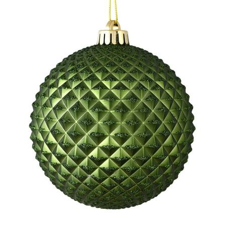 a green christmas ornament hanging from a string