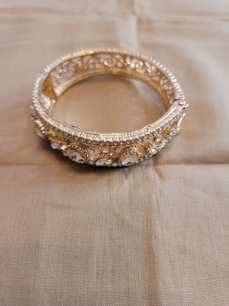 The bangle has 5 carats of round and oval clear zircon with a swirled open design on the band.  Side opening.  Size medium.  14K gold plated. Victorian Bracelet, Genoa, Open Design, Bangle Bracelet, Body Jewelry, Jewelry Inspiration, Diamond Bracelet, Bangle Bracelets, Boho Chic