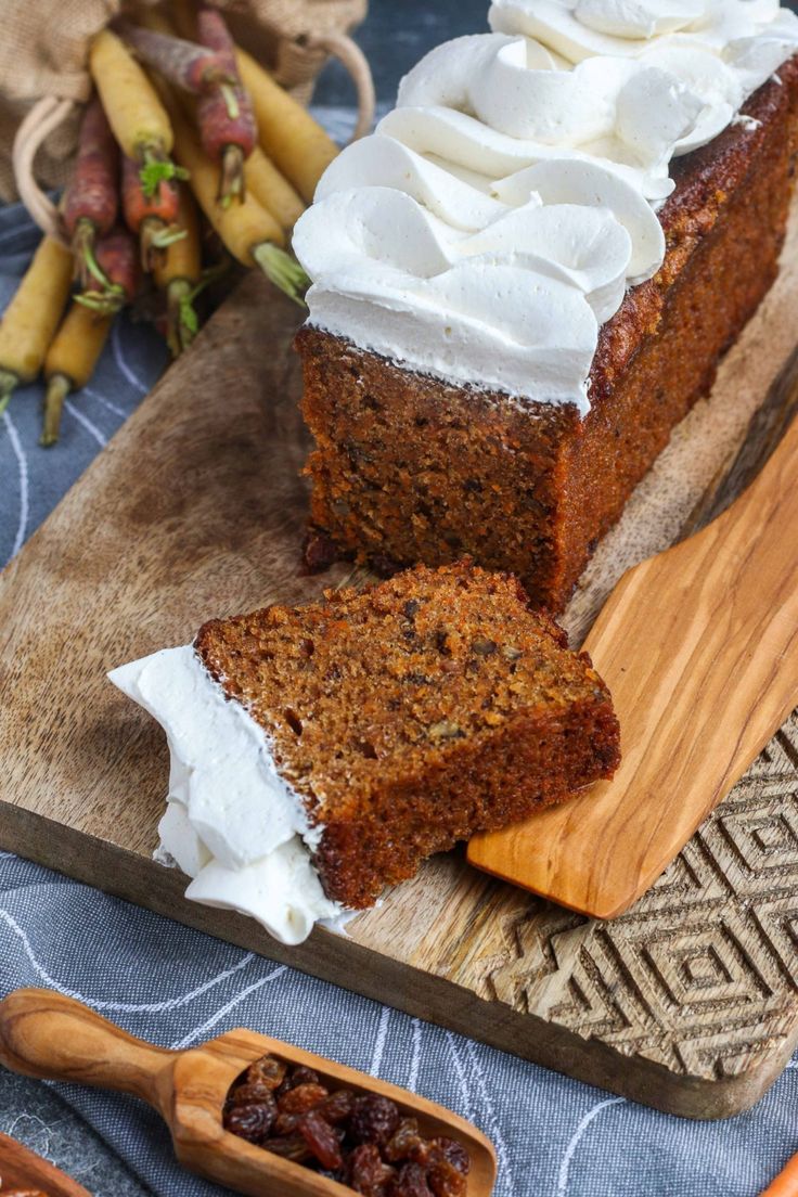 carrot cake with cream cheese frosting on a cutting board