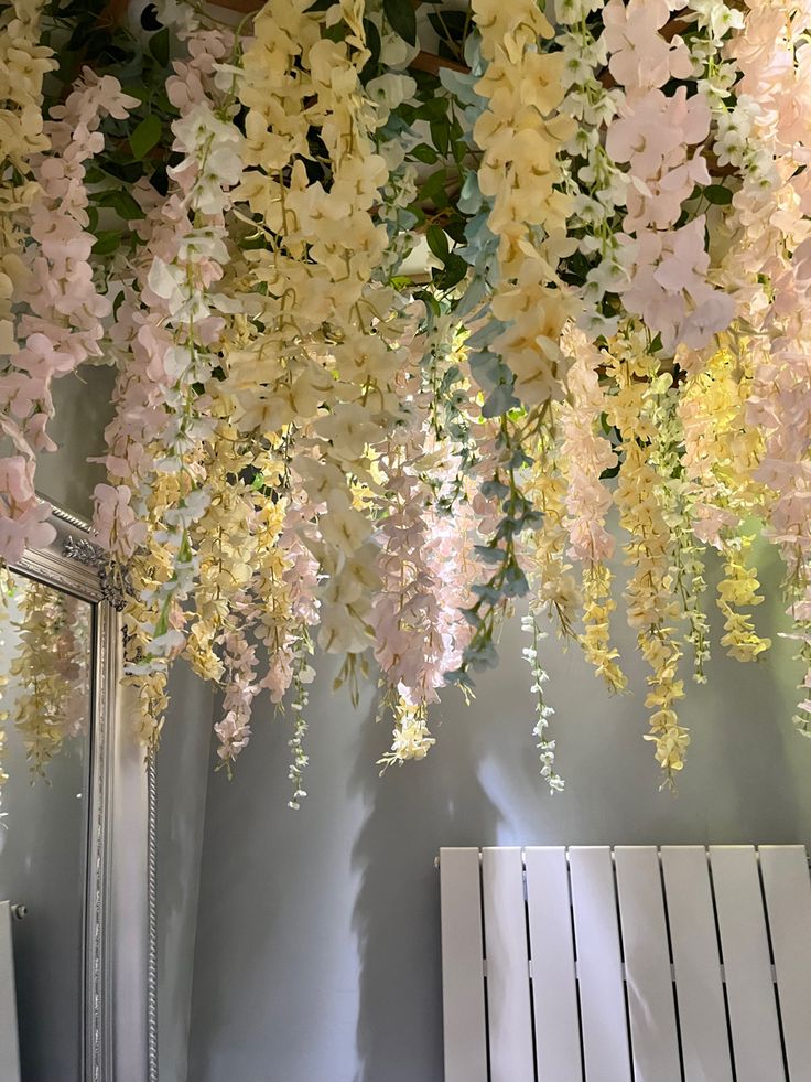 the flowers are hanging from the ceiling above the radiator in the bathroom area