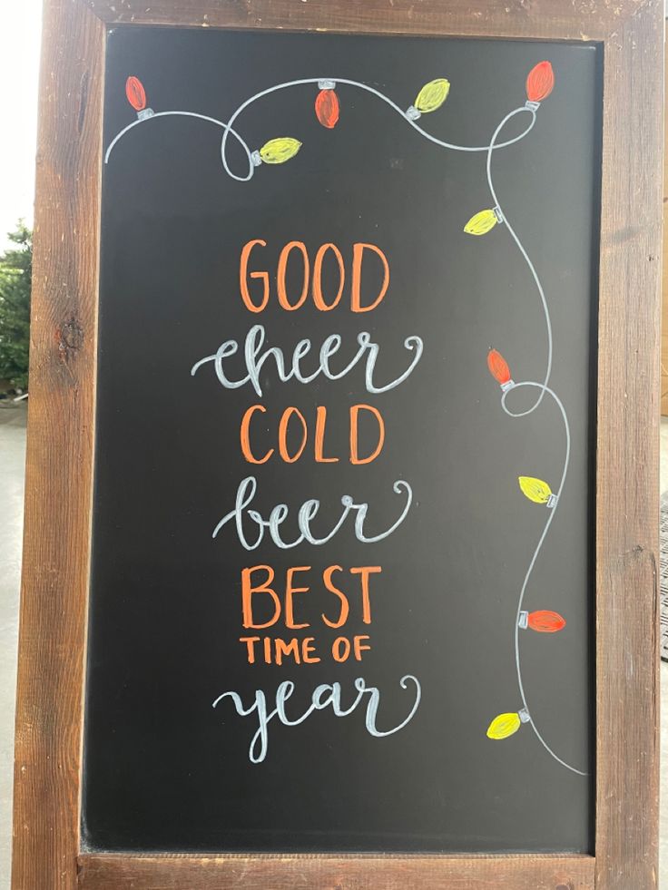 a chalkboard sign that says good cheer cold beer best time of year