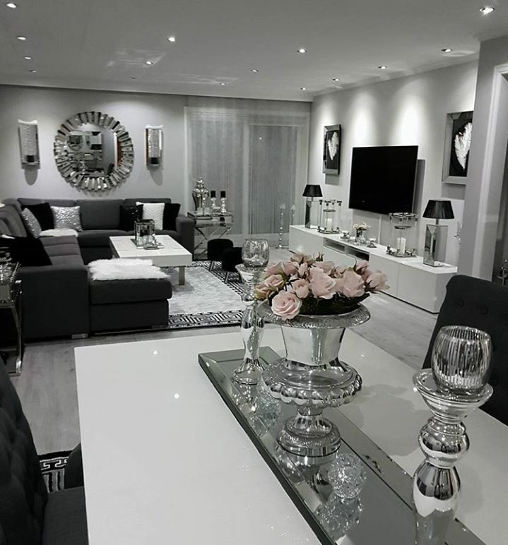 a living room filled with furniture and a flat screen tv mounted to the wall next to a fireplace