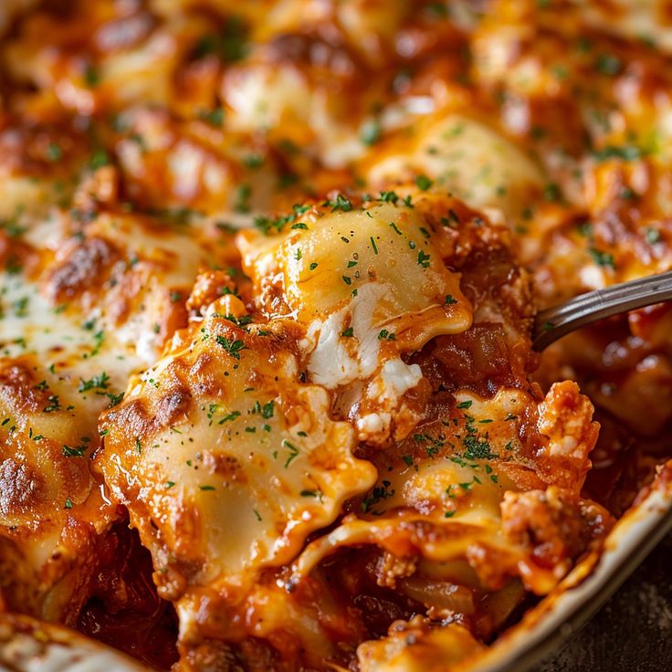 a casserole dish with meat, cheese and sauce