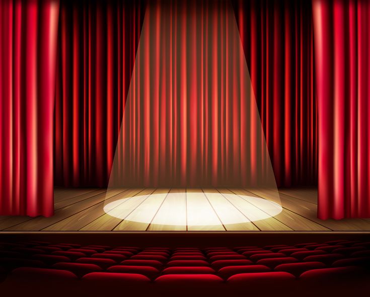 an empty theater stage with red curtains