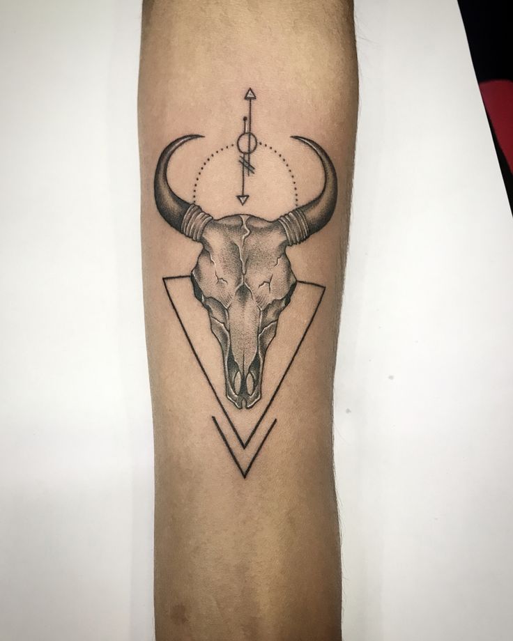 a bull's head with an arrow on the side of his leg is shown