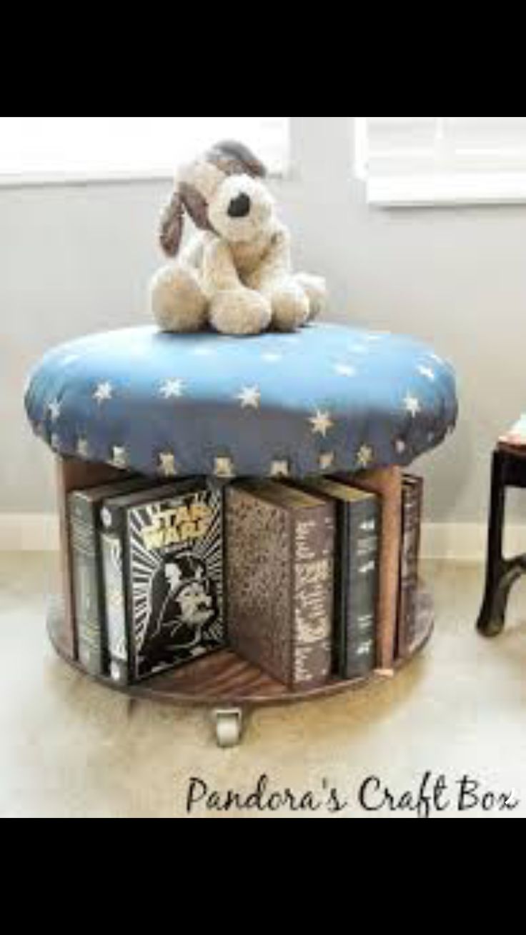 there is a stuffed dog sitting on top of a book shelf