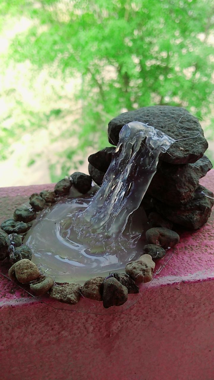 a fountain made out of rocks and water