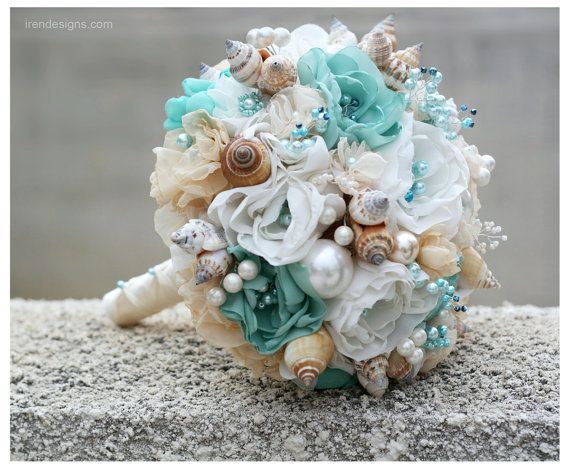 a bridal bouquet with seashells and pearls