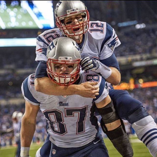 two football players hugging each other on the field