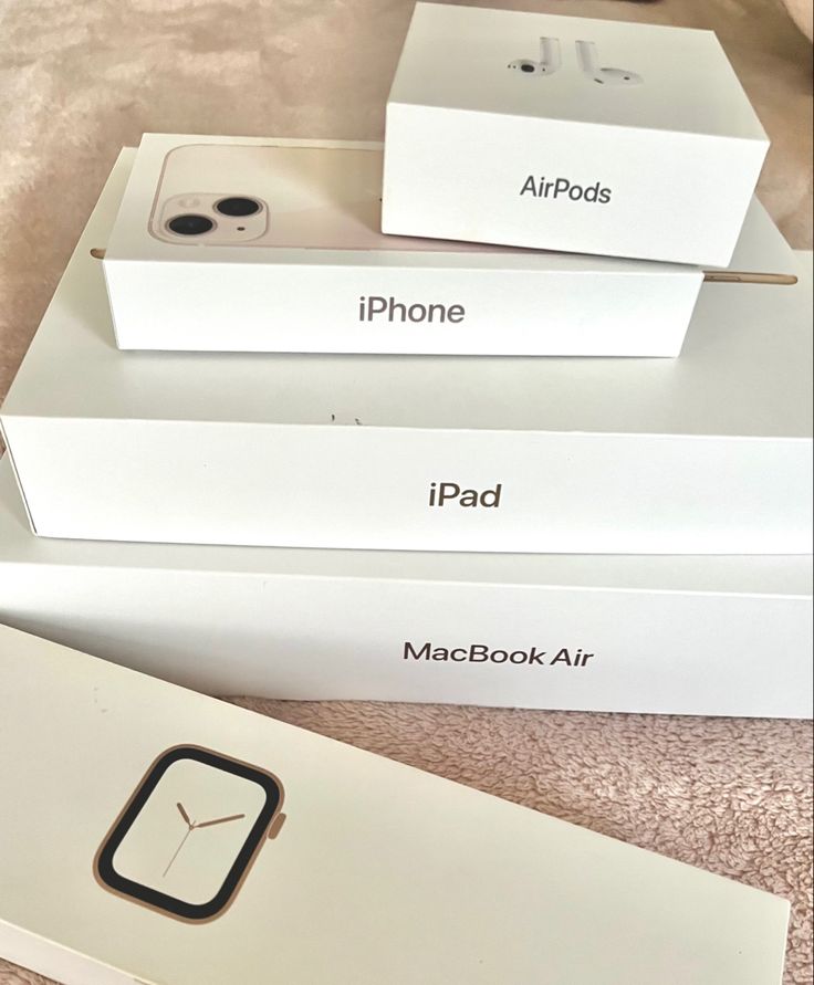 three boxes with apple products sitting on top of each other