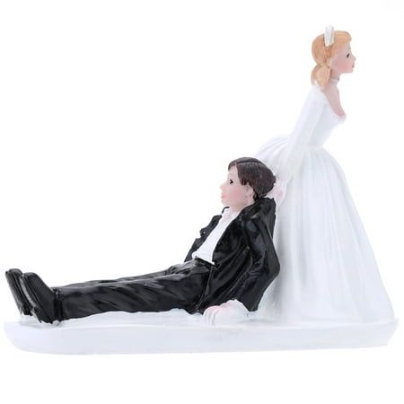 a bride and groom figurine laying on the ground