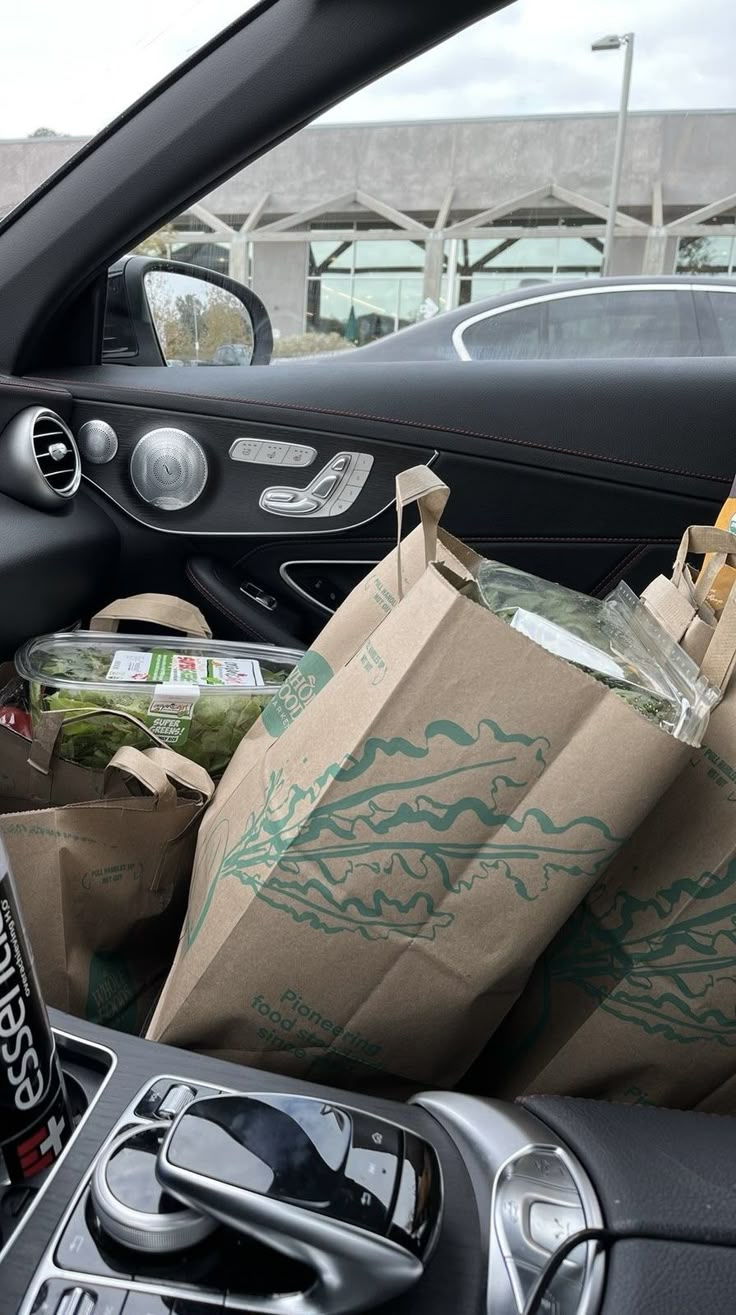 a car filled with food and drinks in it's passenger seat