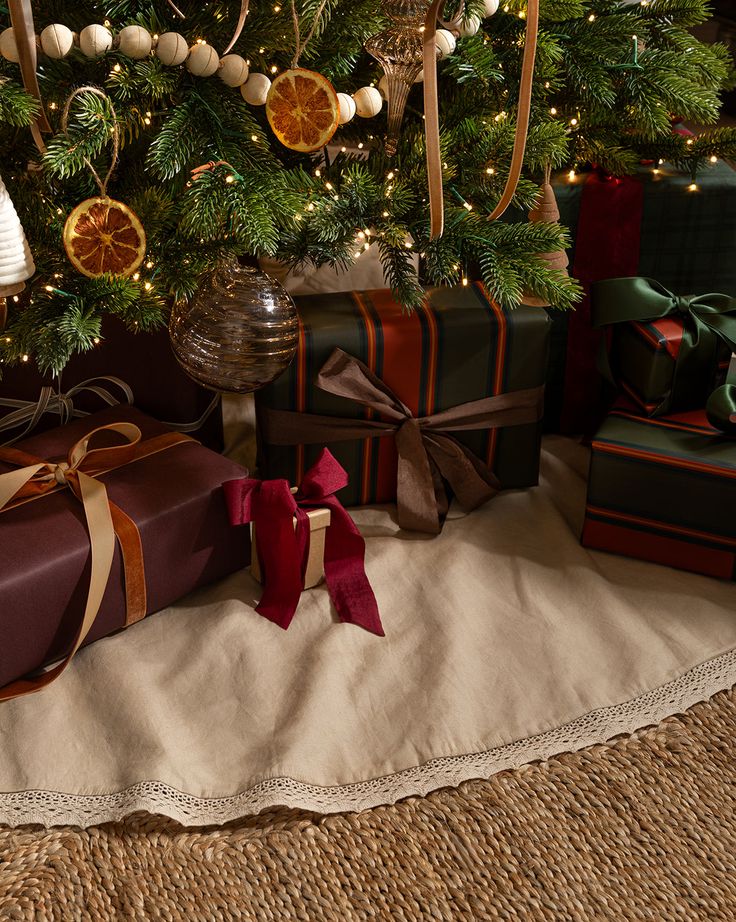 presents under the christmas tree are wrapped in brown paper and tied with twine ribbons