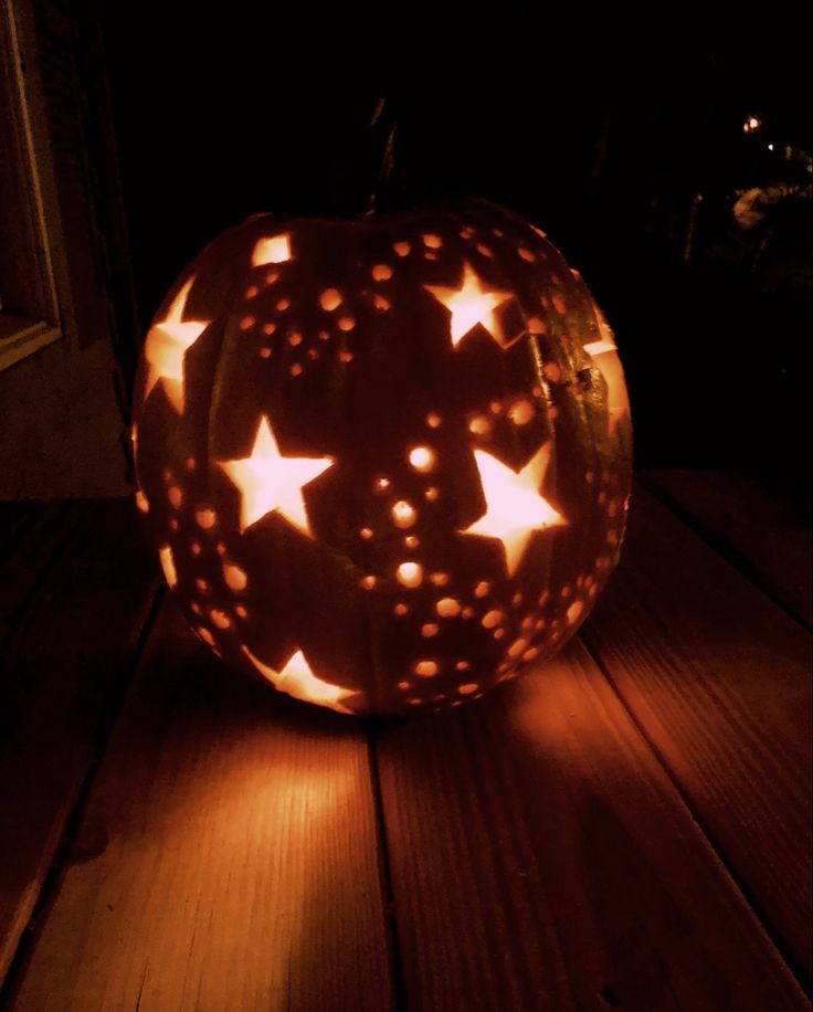 a carved pumpkin with stars on it