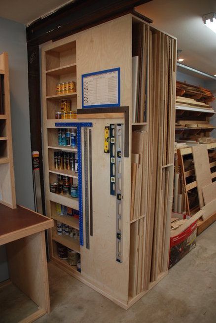 a kitchen pantry with shelves, drawers and other items on the shelf in front of it