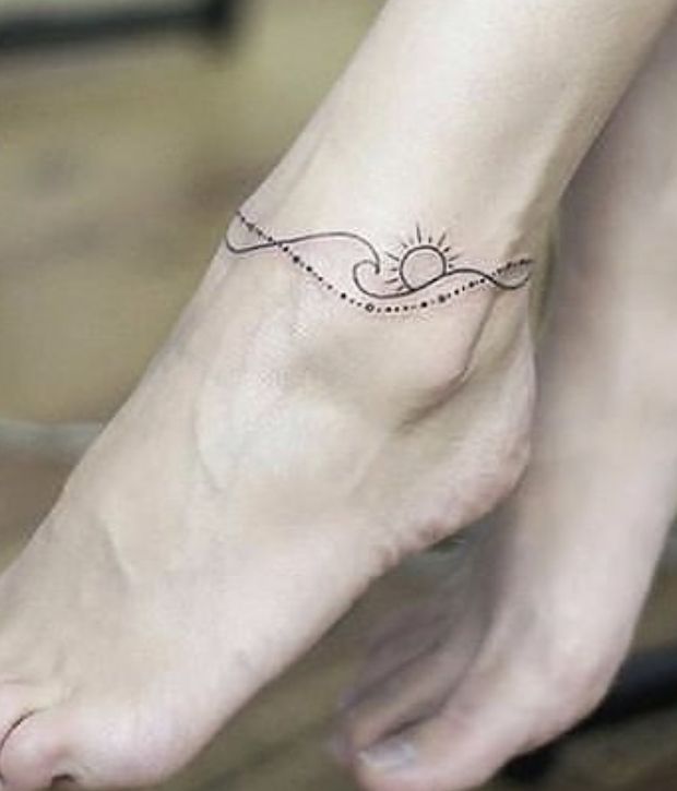 a woman's foot with a small tattoo on it