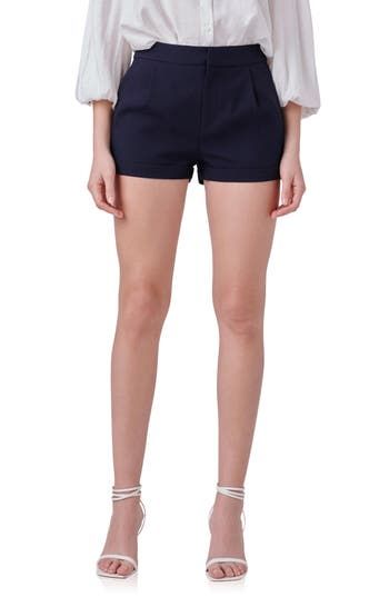 Tailored pleats polish these staple shorts that are made with an on-trend low-rise waist for a modern touch. 2 1/4" inseam 74% polyester, 20% cotton, 6% spandex Hand wash, dry flat Imported Fitted Pleated Shorts, Pleated High-waisted Shorts For Work, Fitted Cotton Pleated Shorts, Fitted Pleated Cotton Shorts, Chic Pleated Cotton Shorts, Classic Summer Bottoms With Pleated Waist, Pleated Fitted Cotton Shorts, Fitted Pleated Shorts For Summer, Trendy Pleated Short Shorts