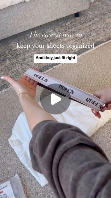 a woman is holding up a piece of paper with the words queen written on it