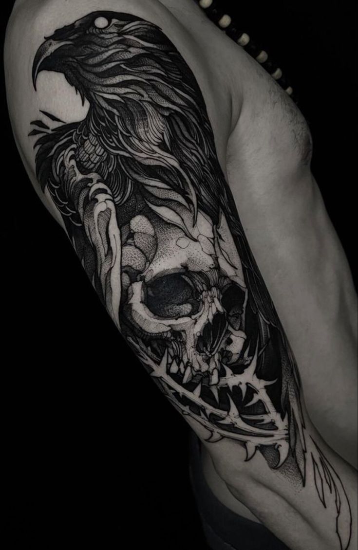 a man's arm with a black and white tattoo on it, which has a skull